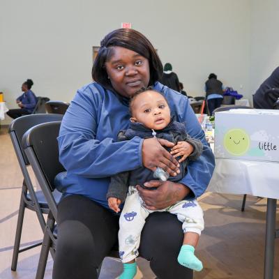Sereniety holds her son at Step Forward's Safe Sleep Summit.