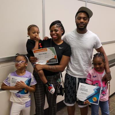 Jaiona and Malik pose with their three children.