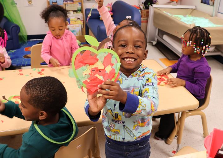 child holding artwork