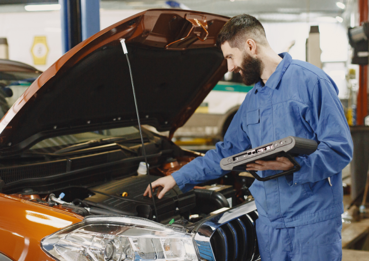 Mechanic works on a car