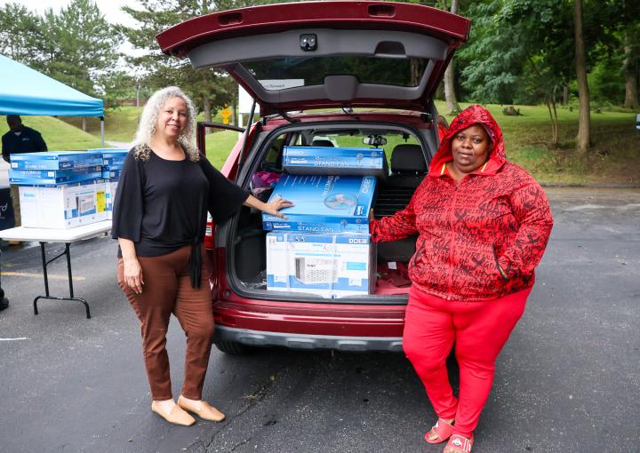 LaVonne (left) helps her client Jateir (right) pick up fans and an air conditioner.  