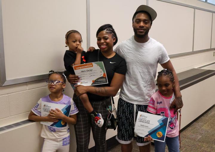 Jaiona and Malik pose with their three children.