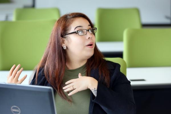 woman talking while sat at computer