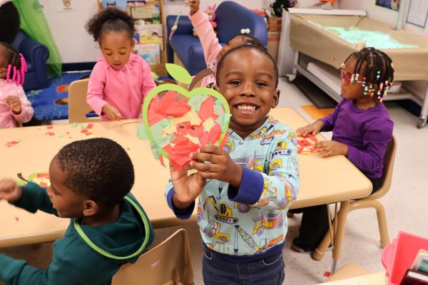 child holding artwork