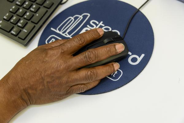 a hand on a computer mouse