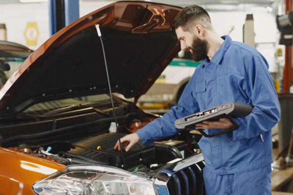 Mechanic works on a car